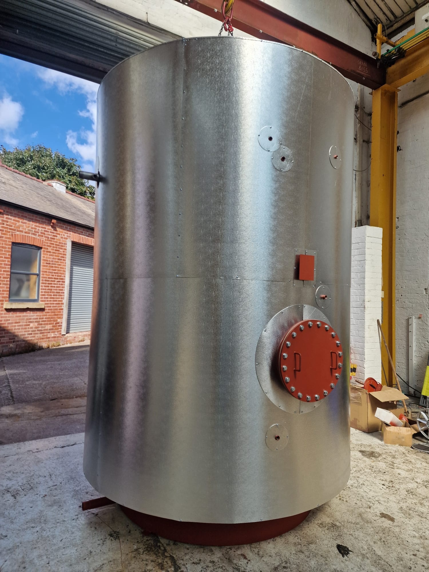 Stainless steel vessel with bolted manway cover ready for inspection